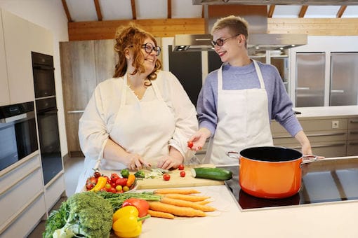 Two ladies cook in the kitchen