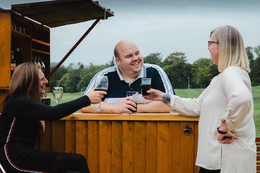 Friends relax with a drink outside