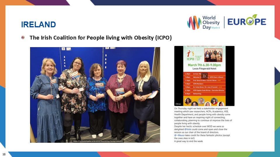 Five people smiling and posing together, each holding a booklet. A poster with event details is displayed beside them.