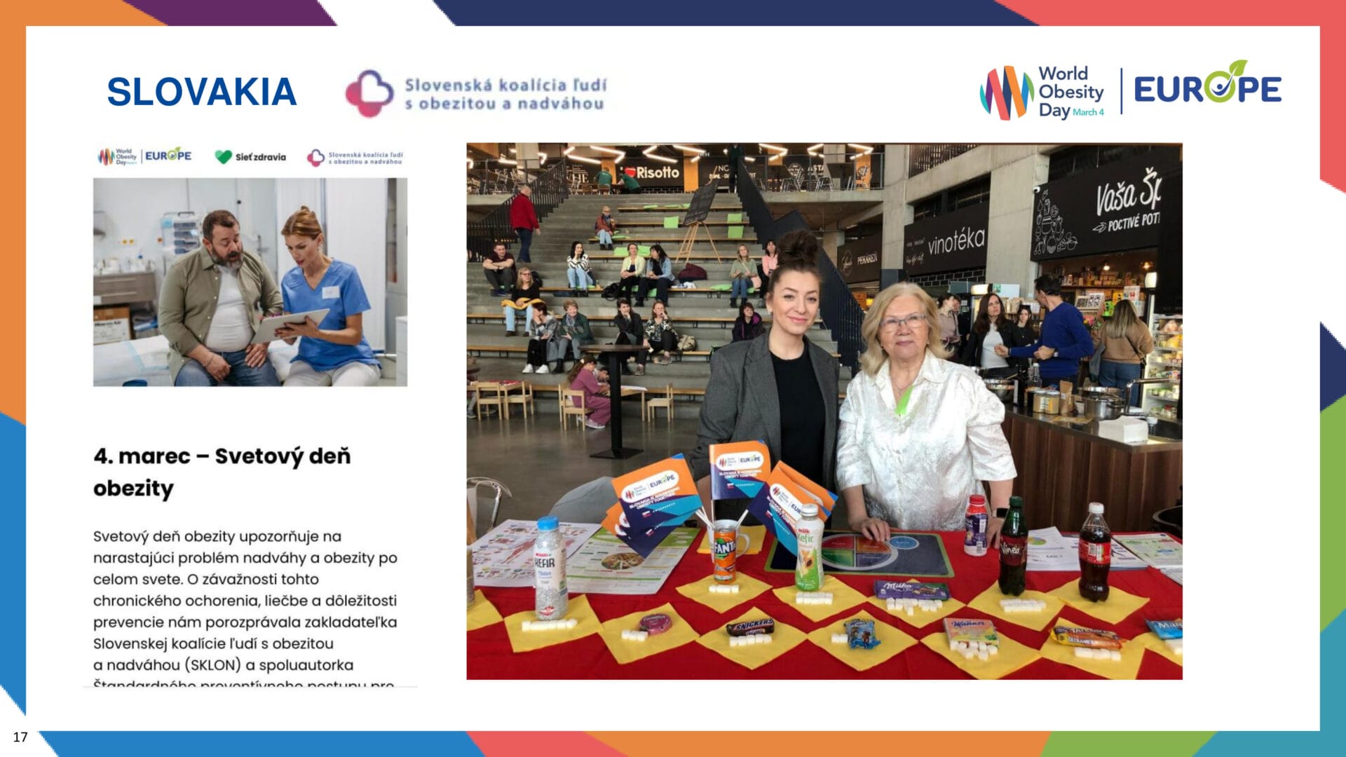 A health awareness booth about World Obesity Day is set up in a public space, with two women standing behind a table displaying informational materials and health products.