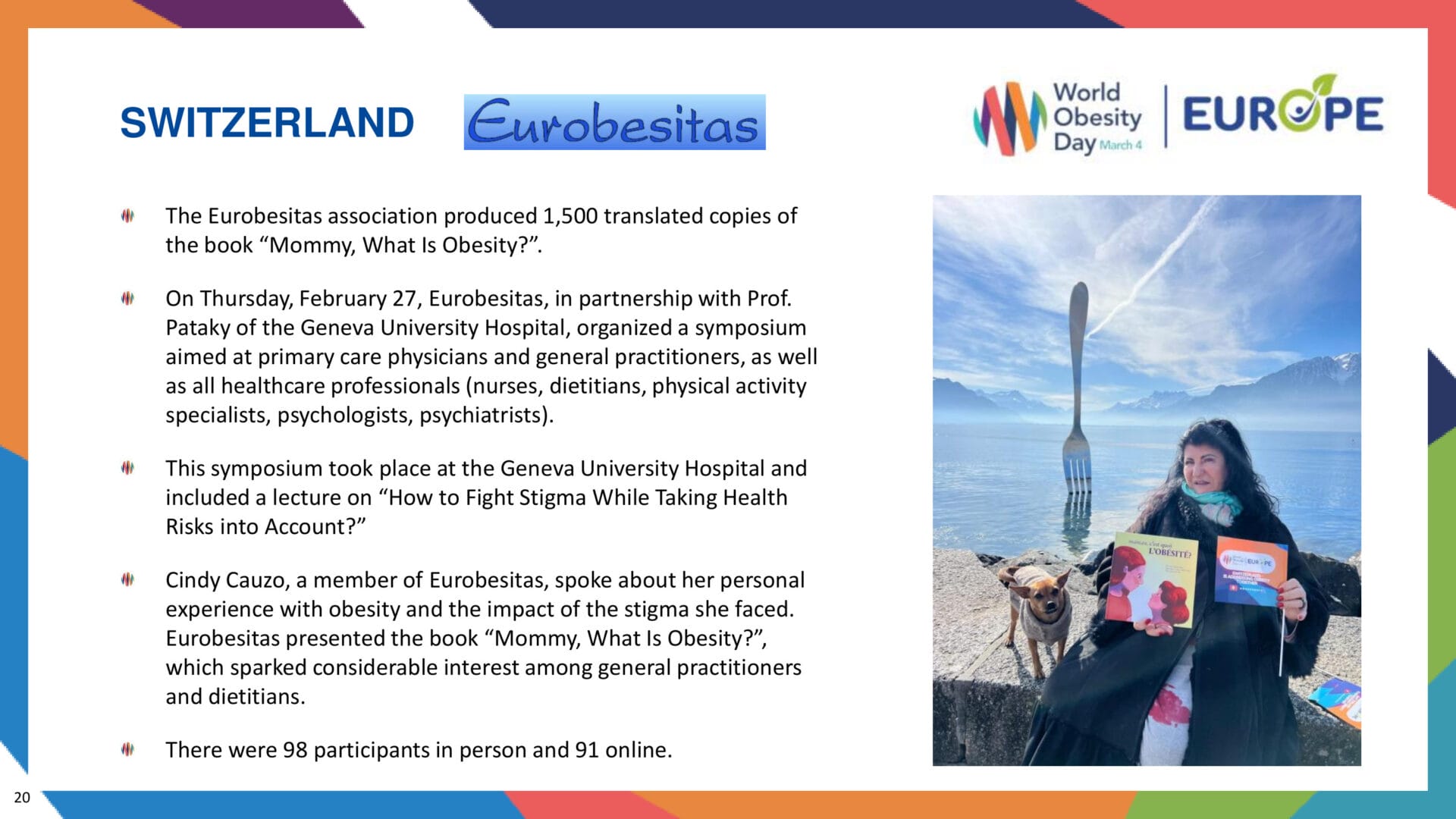 A person holding a book and a dog.